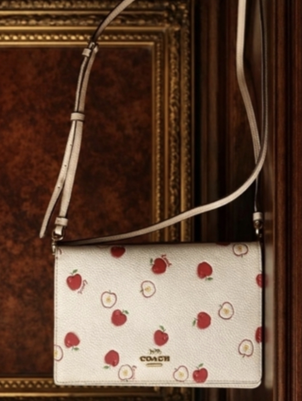 Coach Anna Foldover Clutch Crossbody Bag in a white color with a red apple print - Picture 2 of 16
